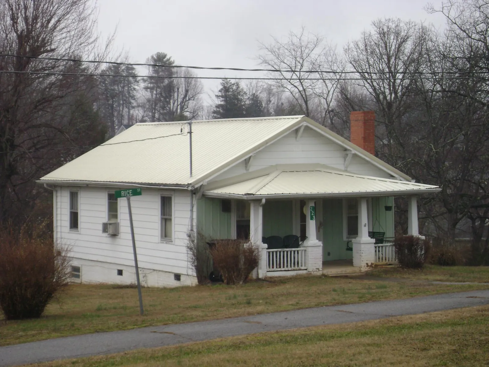 White metal roof on a craftsman bungalow at a street corner in West Elizabeth