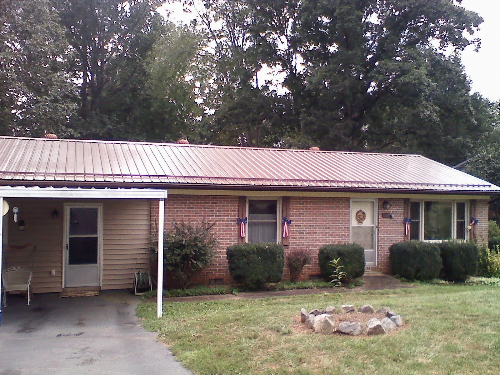Bronze metal roof and carport on a brick ranch home — Roof Repair work by our crew in West Elizabeth