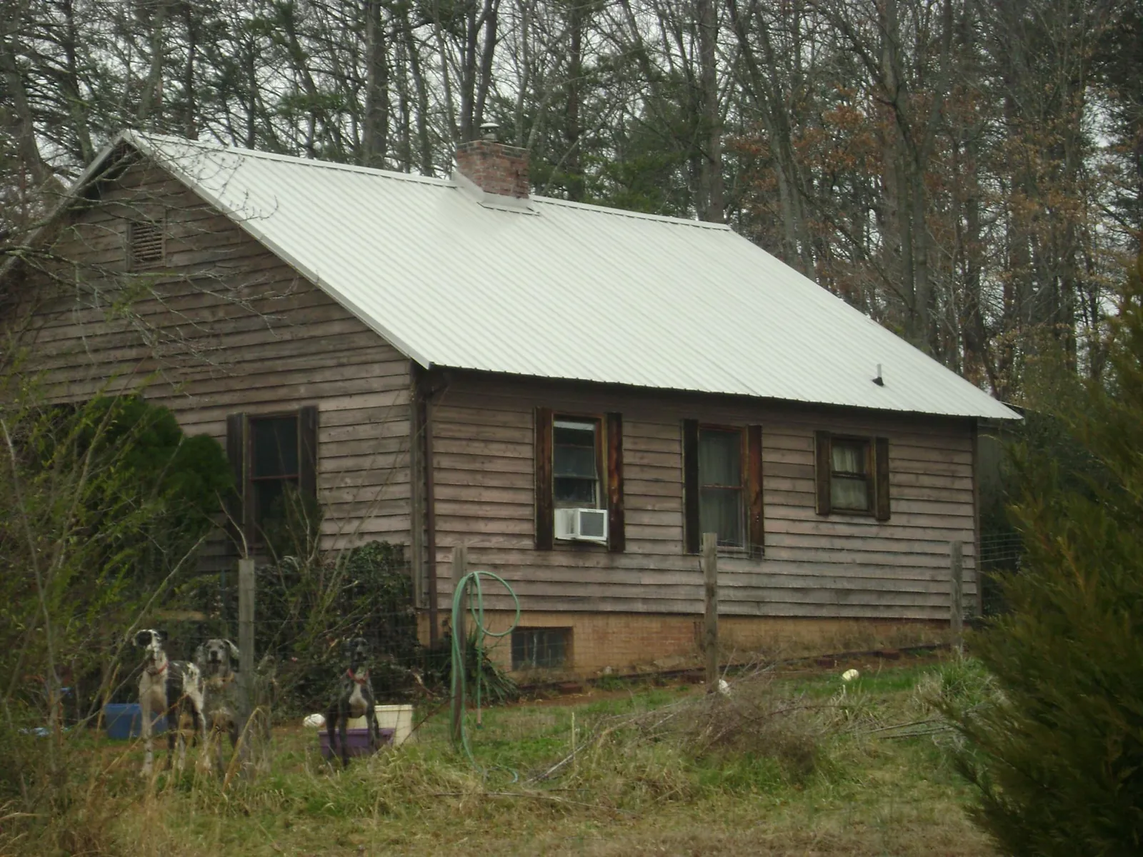 White metal roof on an old wood sided farmhouse, from a Metal Roof Installation job in West Elizabeth